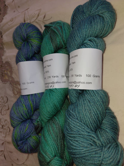 Three skeins of yarn in teal, green, and blue on anagoraonline.com