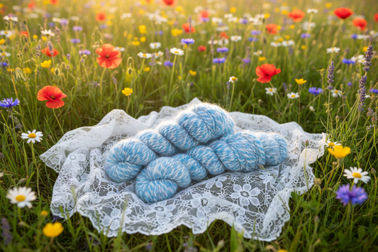 Hand-Dyed Angora Skeins on White Shawl in Wildflower Field